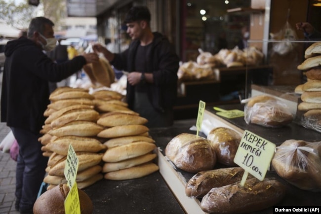 FILE - A man buys bread in Ulus area of the capital Ankara, Turkey, on May 5, 2022. (AP Photo/Burhan Ozbilici, File)