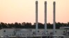 FILE - The sun rises behind the landfall facility for the Nord Stream 1 Baltic Sea pipeline and the transfer station for the OPAL gas pipeline, Baltic Sea Pipeline Link, in Lubmin, Germany, July 21, 2022. 
