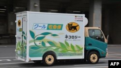 FILE: Japan's Toyota Motor displays the new electric trucks, a one-ton capacity and equipped with compartments to keep cool and frozen, in Tokyo on March 1, 2013. The EV truck, including its refrigerator and freezer, is powered by Li-ion batteries, which Toyota seeks to replace.