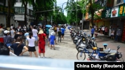 People line up at a nucleic acid testing site amid lockdown measures to curb the COVID-19 outbreak in Sanya, Hainan province, China August 6, 2022. 