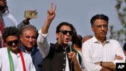 FILE - Pakistan’s former Prime Minister Imran Khan, center, speaks during a rally in Islamabad, May 26, 2022. Police arrested Shahbaz Gill, a close associated of Khan, Aug. 9, 2022, for allegedly inciting army officers to mutiny.