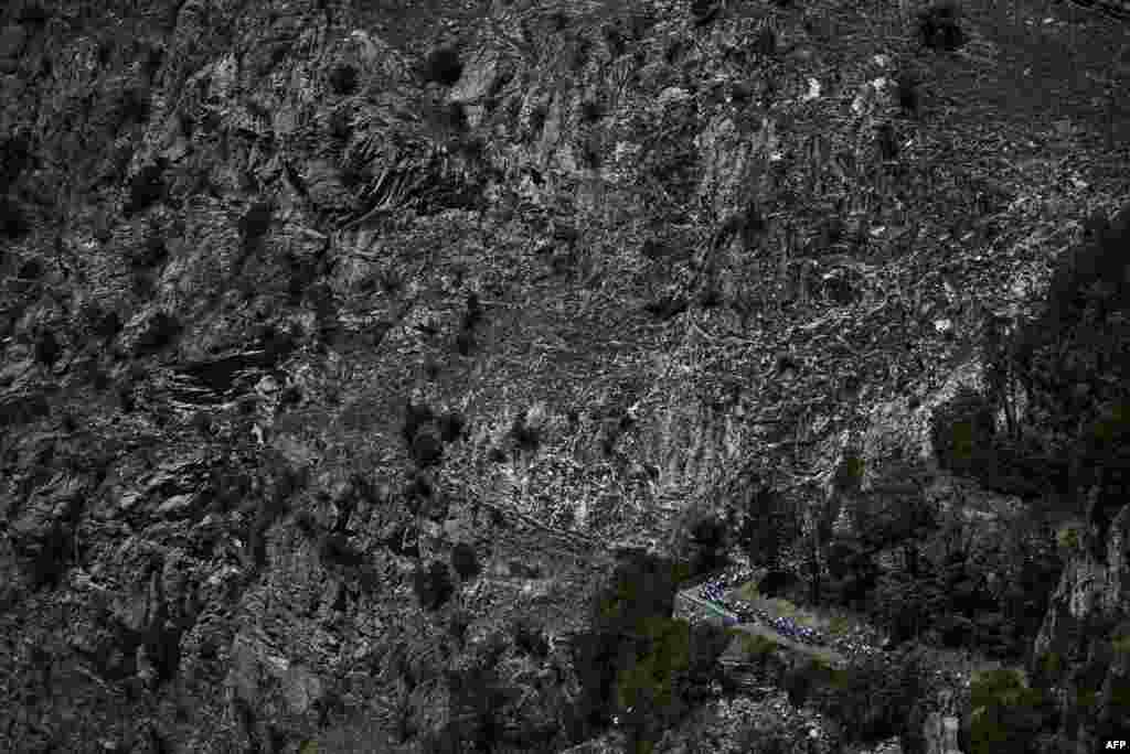 The pack of riders cycle in the ascent of Montvernier during the 11th stage of the 109th edition of the Tour de France cycling race, 151,7 km between Albertville and Col du Granon Serre Chevalier, in the French Alps.