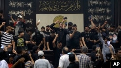 Iraqi protesters fill the parliament building in Baghdad, Iraq, July 31, 2022. Thousands of followers of influential Shiite cleric Muqtada al-Sadr are protesting failed government formation efforts led by al-Sadr's rivals.