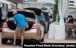 In this undated photo, vehicles line up at a Houston, Texas, food distribution site sponsored by the Houston Food Bank. (Courtesy - Houston Food Bank)