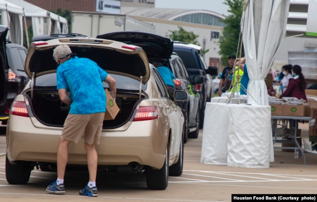 In this undated photo, vehicles line up at a Houston, Texas, food distribution site sponsored by the Houston Food Bank. (Courtesy - Houston Food Bank)
