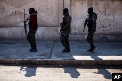 FILE - U.S.-backed Syrian Democratic Forces soldiers search for Islamic State militants in Hassakeh, Syria, Jan. 28, 2022. The U.S. Central Command said in a news release it killed Maher al-Agal, a top leader of the Islamic State in Syria, in a drone strike.