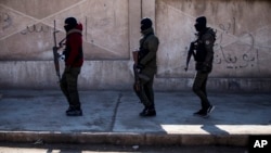 FILE - U.S.-backed Syrian Democratic Forces soldiers search for Islamic State militants in Hassakeh, Syria, Jan. 28, 2022. 