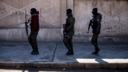 FILE - U.S.-backed Syrian Democratic Forces soldiers search for Islamic State militants in Hassakeh, Syria, Jan. 28, 2022. 