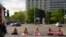 Climate activist Lina Schinkoethe, left, and her mother Solvig Schinkoethe, second from left, sit with their hands glued to the ground during a protest with the group Uprising of the Last Generation in Berlin, Germany, Tuesday, June 21, 2022.