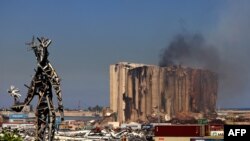 Smoke rises from Beirut&#39;s grain silos that were severely damaged in 2020 by a huge explosion. The fire at the silos, at risk of collapse due to severe damage, happened at the start of the month because of fermentation of remaining grain stocks, along with rising temperatures.