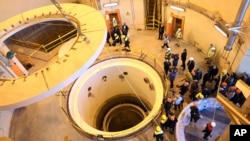 FILE - In this photo released by the Atomic Energy Organization of Iran, technicians work at the Arak heavy water reactor's secondary circuit, as officials and media visit the site, near Arak, 250 kilometers southwest of Tehran, Dec. 23, 2019. 