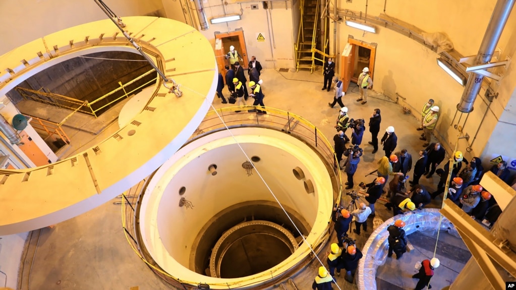 FILE - In this photo released by the Atomic Energy Organization of Iran, technicians work at the Arak heavy water reactor's secondary circuit, as officials and media visit the site, near Arak, 250 kilometers southwest of Tehran, Dec. 23, 2019. 