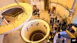 FILE - In this photo released by the Atomic Energy Organization of Iran, technicians work at the Arak heavy water reactor's secondary circuit, as officials and media visit the site, near Arak, 250 kilometers southwest of Tehran, Dec. 23, 2019. 