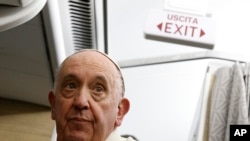 Pope Francis speaks to journalists aboard the papal flight back from Canada Saturday, July 30, 2022.
