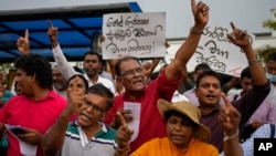 Members of the People's Liberation Front shout anti-government slogans during a protest denouncing corruption and demanding a fresh parliamentary election in Colombo, Sri Lanka, July 27, 2022. 