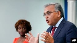 FILE: White House COVID-19 Response Coordinator Ashish Jha, right, speak during a briefing at the White House as Press Secretary Karine Jean-Pierre listens at left. Taken 7.25.2022