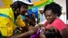 FILE - A health worker vaccinates a child against malaria in Homabay County, western Kenya.