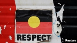 FILE - A sticker of the Australian Aboriginal Flag along with the word 'RESPECT' is pictured on a structure at the Aboriginal Tent Embassy, a site of protest since 1972, in Canberra, Australia, May 4, 2022.