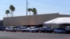 Dozens of vehicles line up to get food boxes at the St. Mary's Food Bank in Phoenix, Arizona, June 29, 2022. Long lines are back at outside food banks around the U.S. as working Americans overwhelmed by inflation increasingly seek handouts to feed their families.