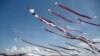 People fly their kites during the Kite Festival at Mertasari beach in Sanur on the Indonesian resort island of Bali, July 31, 2022.