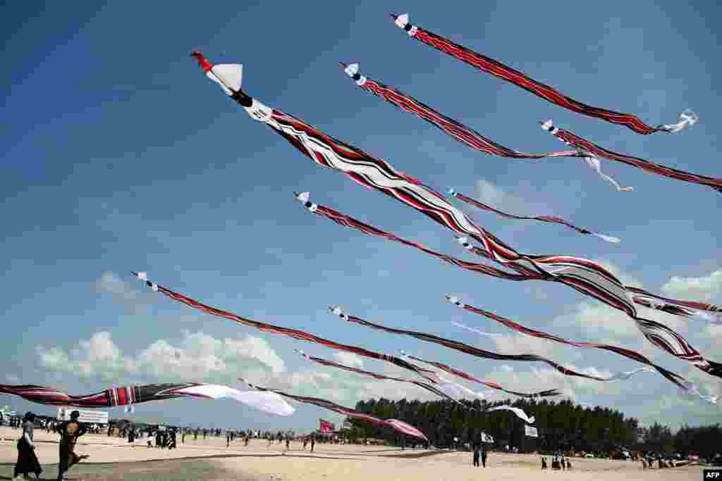 People fly their kites during the Kite Festival at Mertasari beach in Sanur on the Indonesian resort island of Bali.