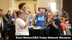 FILE - Abortion-rights supporters react as early polls showed that voters rejected a state constitutional amendment that would have declared there is no right to abortion, at a Kansans for Constitutional Freedom election watch party in Overland Park, Kan., Aug. 2, 2022.