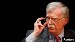FILE - Former White House national security adviser John Bolton adjusts his glasses during his lecture at Duke University in Durham, North Carolina, Feb. 17, 2020. 