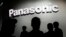 FILE - People walk by the Panasonic booth during CES International, on Jan. 9, 2018, in Las Vegas. 
