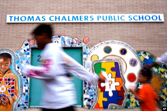 Thomas Chalmers Public School sign is seen outside of school in Chicago, Wednesday, July 13, 2022. (AP Photo/Nam Y. Huh)