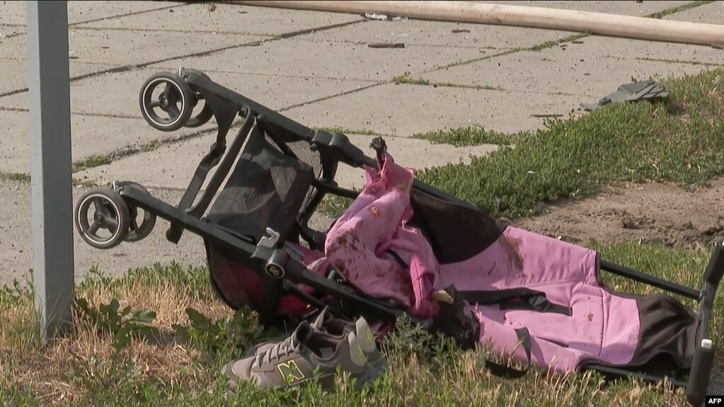 A stroller is seen lying on the ground after Russian missiles strike Vinnytsia, in central Ukraine, killing at least 20 people including three children, in this video grab taken from AFPTV footage July 14, 2022, and released July 15, 2022. 