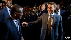 FILE: French president Emmanuel Macron is welcomed by Cameroon Prime Minister Joseph Dion Ngute upon his arrival at the Nsimalen international airport of Yaounde. Taken July 25, 2022.