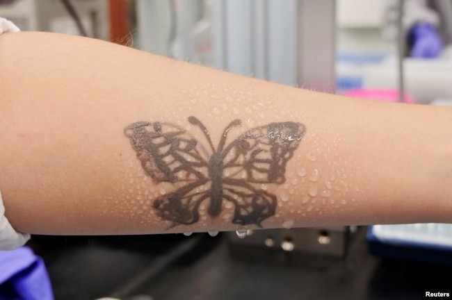 Water sprays on arm are seen with an electronic tattoo (e-tattoo) for the wettability test at the Korea Advanced Institute of Science and Technology (KAIST) in Daejeon, South Korea, July 26, 2022. (REUTERS/Minwoo Park)