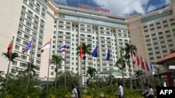 People walk in front of the Sokha hotel during the 55th ASEAN Foreign Ministers Meeting (55th AMM) in Phnom Penh, Aug. 2, 2022.