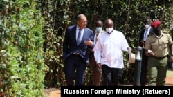 Russian Foreign Minister Sergei Lavrov and Ugandan President Yoweri Museveni walk during their meeting in Entebbe, Uganda. Taken 7.26.2022