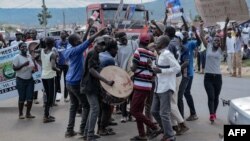 FILE: Youth supporters of local elective seats aspirants react on the streets of Kisumu, western Kenya, on July 16, 2022. - The number of young voters registered for Kenya's August elections has dropped since the last poll five years ago,