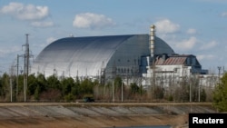 FILE - A general view of the New Safe Confinement (NSC) structure over the old sarcophagus covering the damaged fourth reactor at the Chernobyl Nuclear Power Plant, in Chernobyl, Ukraine April 7, 2022.