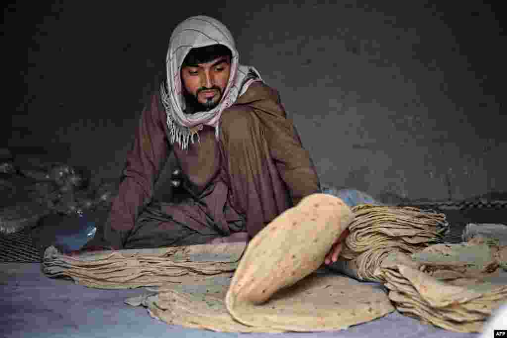 A man stacks flatbread in a bread factory in Kandahar, Afghanistan.