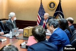 U.S. President Joe Biden is shown a model of a safe house, center, where Ayman al-Zawahiri was hiding, as he meets with his national security team at the White House in Washington to discuss the counterterrorism operation to take out al-Zawahiri, in this July 1, 2022, handout photo obtained on Aug. 2, 2022. (The White House/Handout via Reuters)