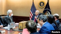 U.S. President Joe Biden is shown a model of a safe house, center, where Ayman al-Zawahiri was hiding, as he meets with his national security team at the White House in Washington to discuss the counterterrorism operation to take out al-Zawahiri, in this