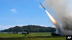 In this photo released by China's Xinhua News Agency, a projectile is launched from an unspecified location in China during long-range live-fire drills by the army of the Eastern Theater Command of the Chinese People's Liberation Army, Thursday, Aug. 4, 2022.