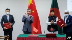 Menteri Luar Negeri China Wang Yi (kedua dari kiri) dan Menlu Bangladesh A.K. Abdul Momen (ketiga dari kiri) dalam penandatanganan kerjasama bilateral di Dhaka, Bangladesh, Minggu (7/8). 