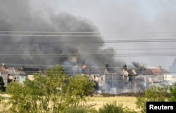 A fire burns during a heat wave, in Rainham, East London, Britain, July 19, 2022.