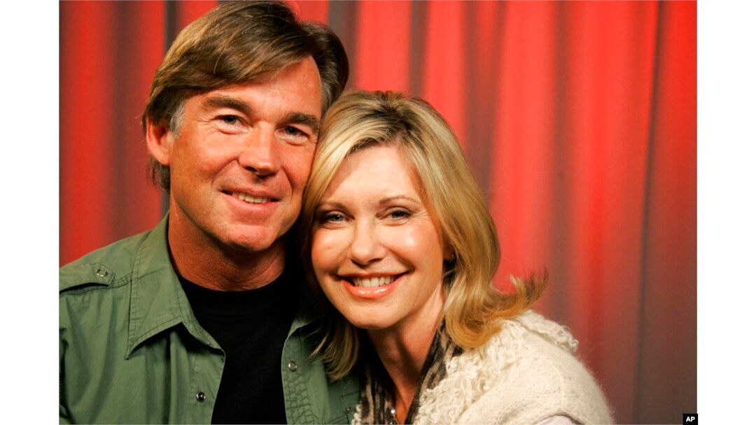 FILE - Olivia Newton-John and her husband John Easterling pose for a portrait in New York, April 2, 2009.