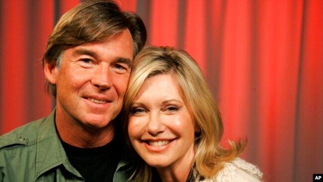 FILE - Olivia Newton-John and her husband John Easterling pose for a portrait in New York, April 2, 2009.