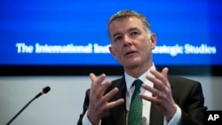 FILE - Richard Moore, chief of Britain's Secret Intelligence Service, speaks at the International Institute for Strategic Studies in London, Nov. 30, 2021. 