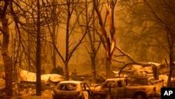 Scorched vehicles and residences line the Oaks Mobile Home Park in the Klamath River community as the McKinney fire burns in Klamath National Forest, Calif., July 30, 2022.