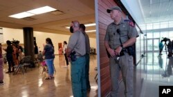 A Texas State Trooper and other law enforcement members listen to the Texas House of Representatives investigative committee during a news conference after they released a full report on the shooting at Robb Elementary School on Sunday, July 17, 2019. 2022, in Uvalde, Texas.  (AP Photo/Eric Gay)