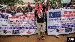 FILE - Protesters chant slogans while marching during a protest to demand peaceful elections and justice for victims of post-election violence in Nairobi, Kenya on June 23, 2022.