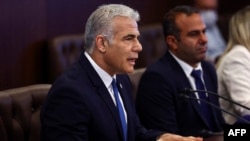 Israeli Prime Minister Yair Lapid addresses a cabinet meeting at his office in Jerusalem on July 24, 2022.