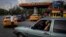 FILE: Drivers wait their turn to fuel their vehicles at a gas station in Havana, Cuba, July 14, 2022 